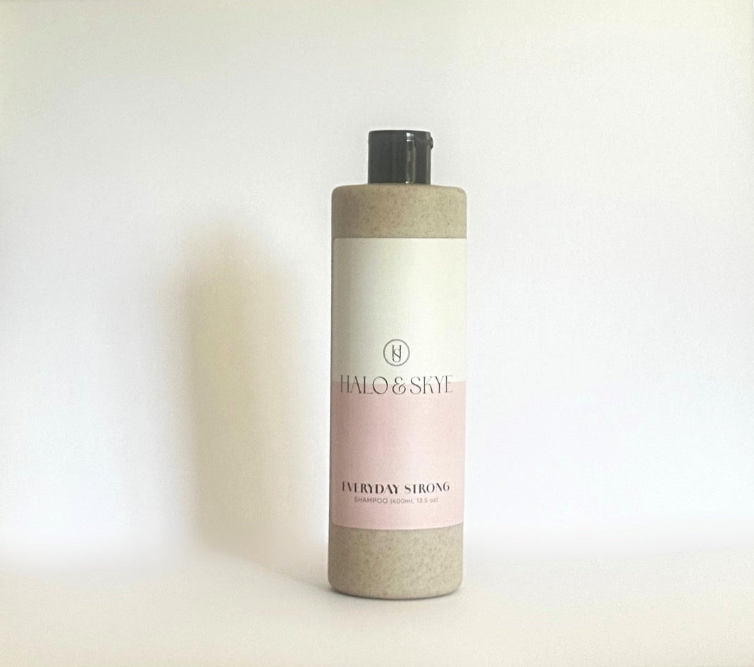 Bottle of shampoo on a light background